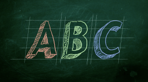 ABC written in chalk on a gridded blackboard